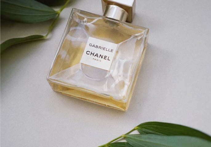 Gabrielle chanel perfume between decoration leaves